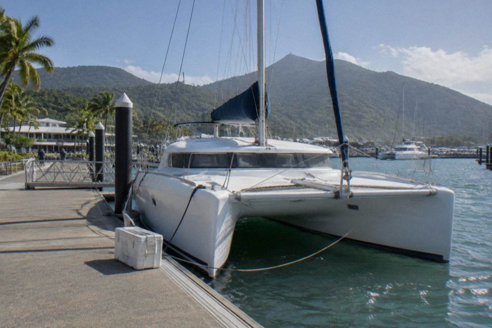 A ferry terminal jetty at morning with a catamaran preparing to depart