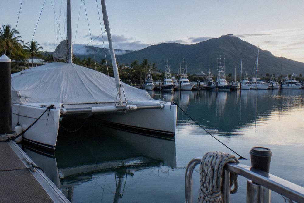 A covered ferry catamaran at a marina berth in Cairns in the morning