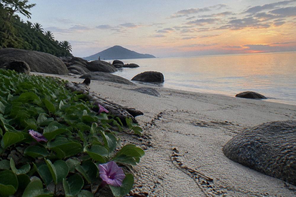 White sand and granite boulders at Nudey Beach with calm sea