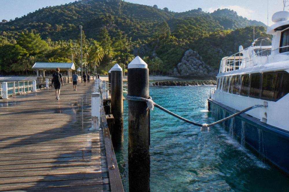 Timber jetty at Fitzroy Island with a ferry at berth and turquoise water below