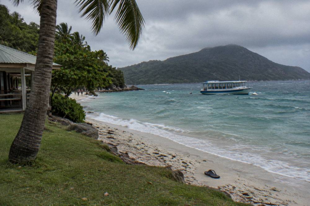 Calm sheltered bay with a coral sand beach and anchored boats