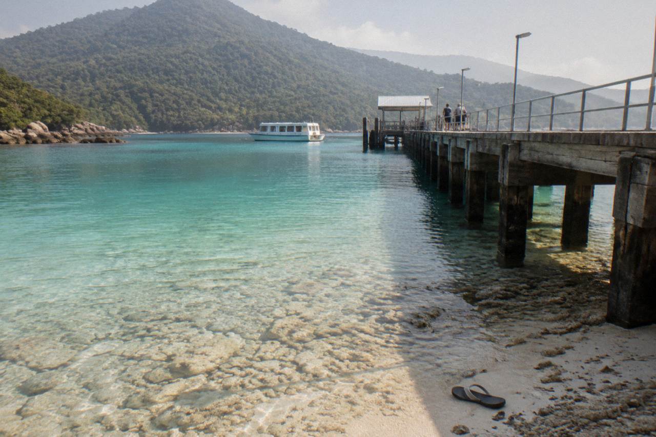 Calm turquoise water over coral rubble at a sheltered tropical island beach